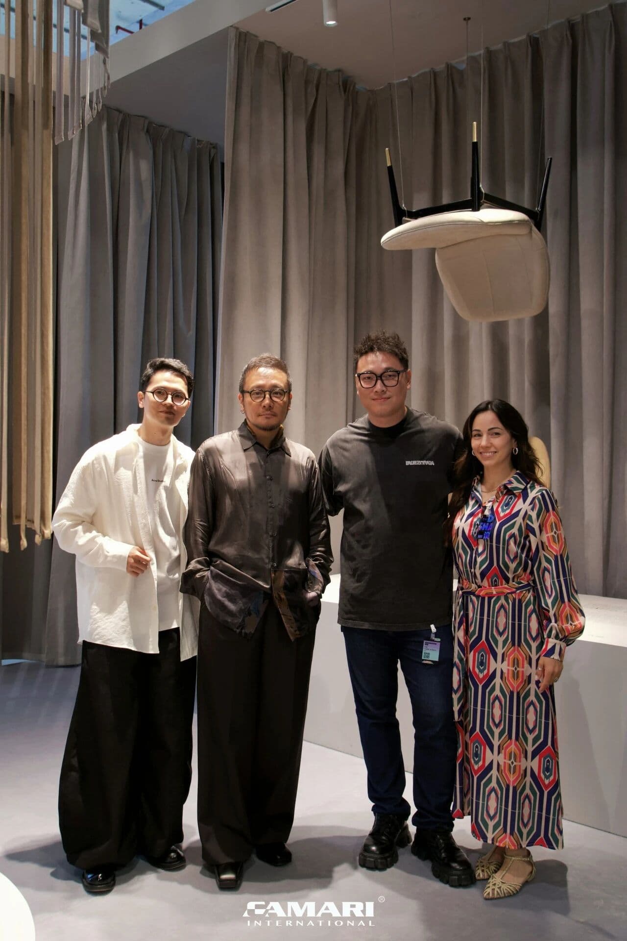 Designer Wu Bin and guests beneath the suspended WEIMO lounge chair at Design Shanghai