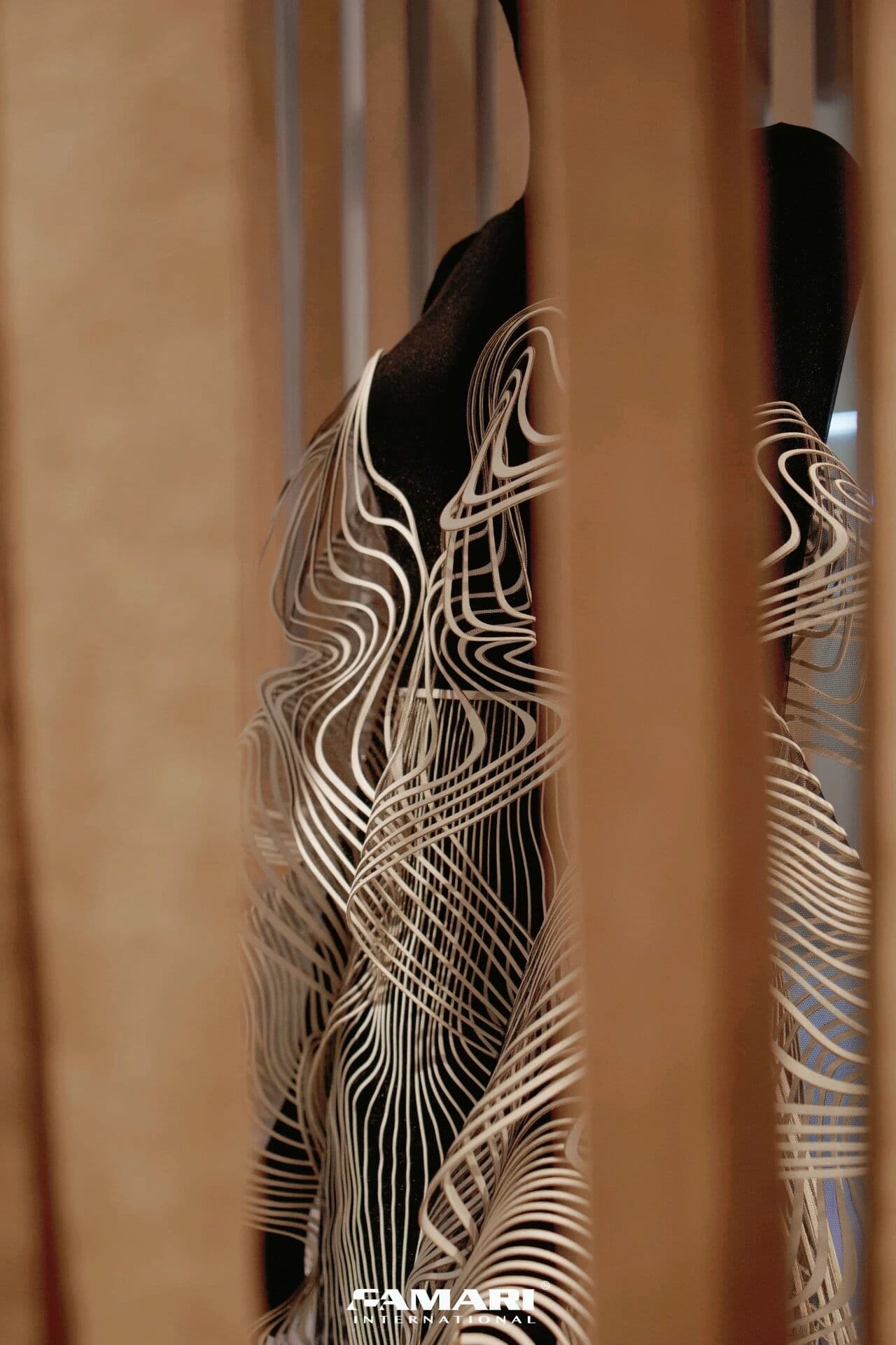 Detail of the flowing white lines on Iris van Herpen's Alcantara garment