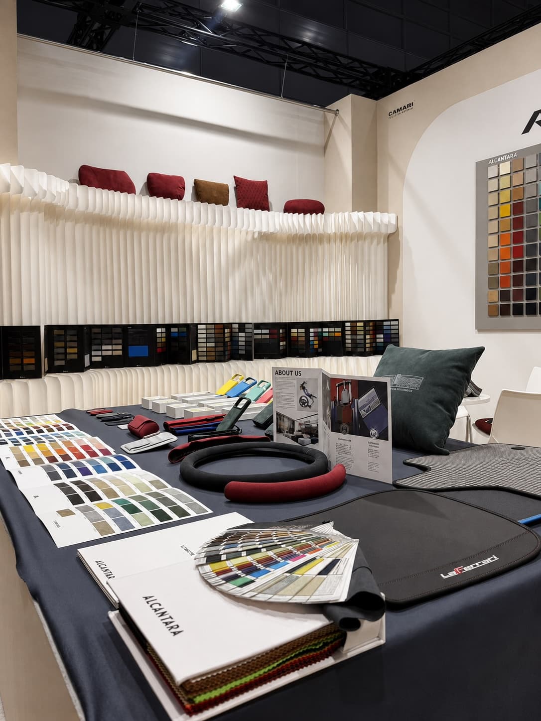 Alcantara samples, colour references, automotive accessories, and lifestyle products at the CAMARI booth
